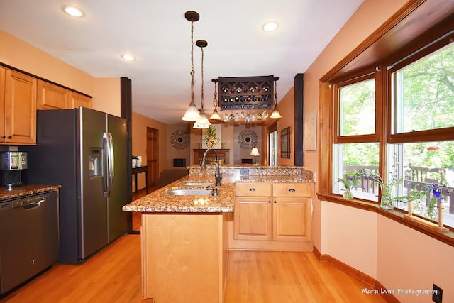 5N850 Ravine Dr, Saint Charles, IL 60175 - kitchen featuring a sink, appliances with stainless steel finishes, light wood-style flooring, a peninsula, and light stone countertops
