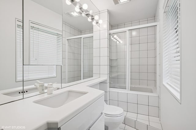 full bathroom with tiled shower / bath combo, toilet, and vanity