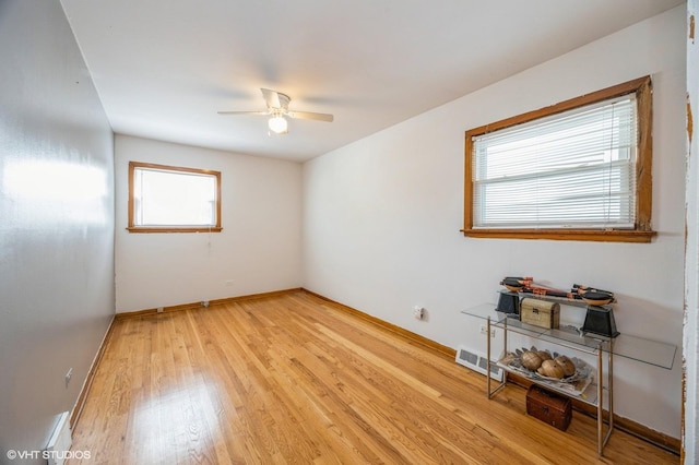 545 Morris Ave, Bellwood, IL 60104 - empty room featuring plenty of natural light, light wood-type flooring, ceiling fan, and baseboards