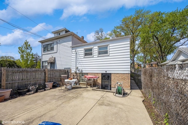 545 Morris Ave, Bellwood, IL 60104 - back of house with a patio area, a fenced backyard, and brick siding