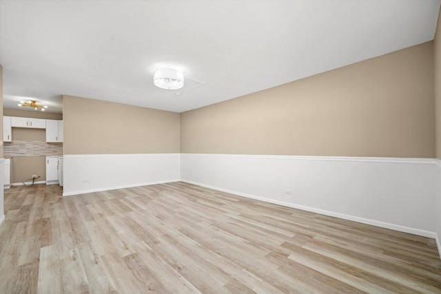 spare room with light wood-style flooring and baseboards
