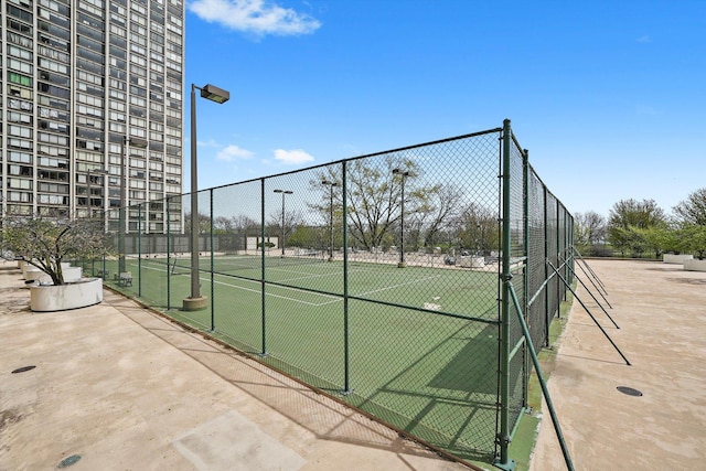 view of tennis court with fence