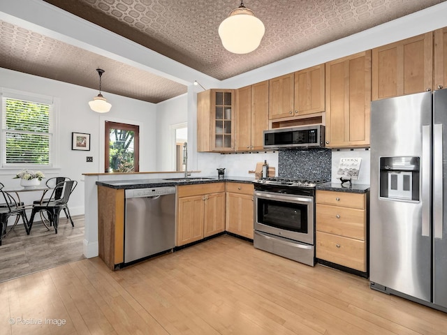 213 S Ashland Ave, La Grange, IL 60525 - kitchen with appliances with stainless steel finishes, a sink, an ornate ceiling, dark countertops, and light wood-type flooring