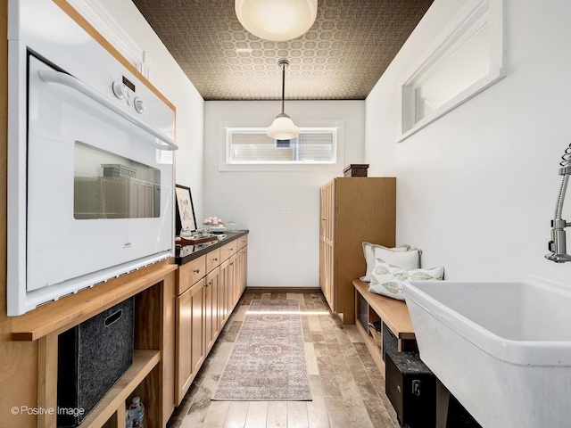 213 S Ashland Ave, La Grange, IL 60525 - kitchen with oven, an ornate ceiling, hanging light fixtures, baseboards, and a sink