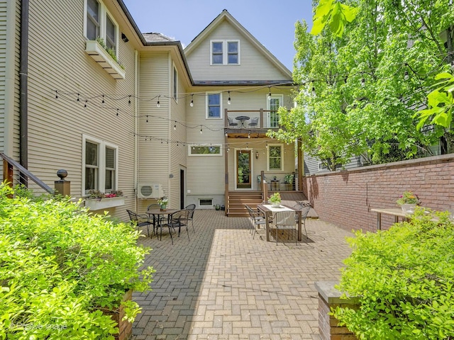 213 S Ashland Ave, La Grange, IL 60525 - rear view of house with a balcony, outdoor dining space, and a patio area