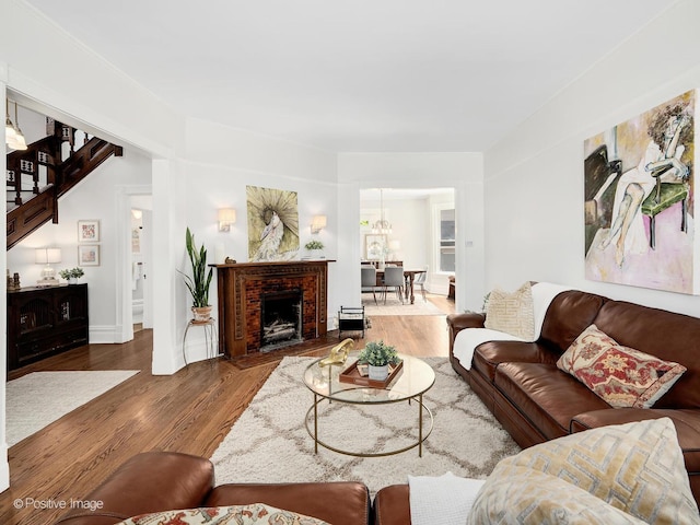 213 S Ashland Ave, La Grange, IL 60525 - living room with wood finished floors, a chandelier, baseboards, and a brick fireplace