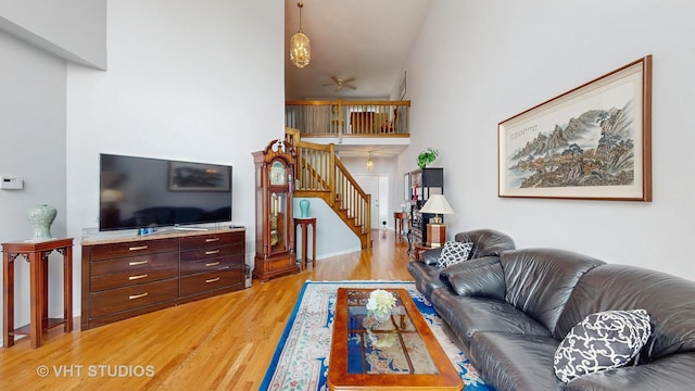 23118 Lacroix Ln, Plainfield, IL 60544 - living area featuring light wood-style flooring, stairway, and a ceiling fan
