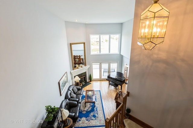 23118 Lacroix Ln, Plainfield, IL 60544 - living room with a chandelier, a fireplace with flush hearth, and wood finished floors