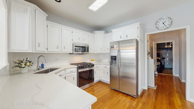 23118 Lacroix Ln, Plainfield, IL 60544 - kitchen featuring stainless steel appliances, light countertops, light wood-style flooring, and white cabinetry