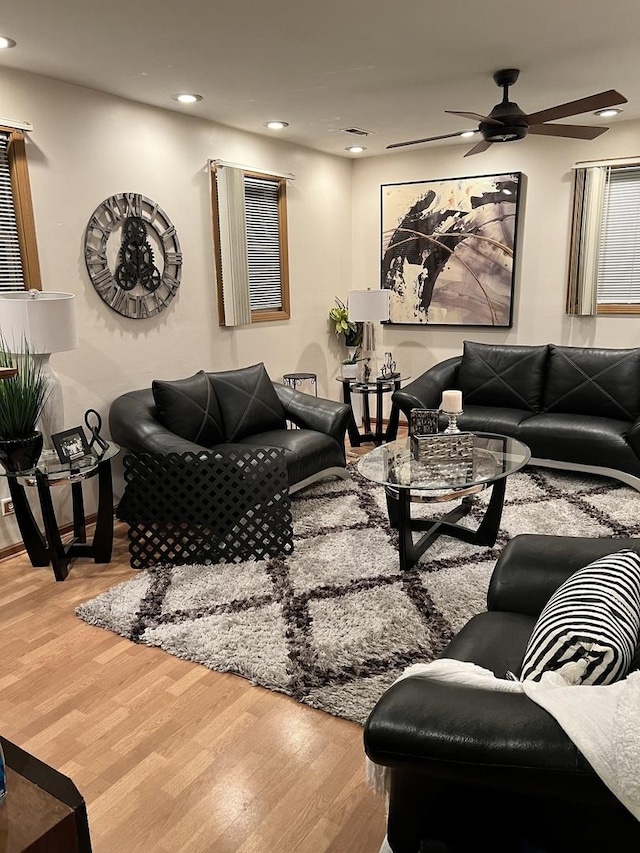 living room with a ceiling fan, recessed lighting, and wood finished floors