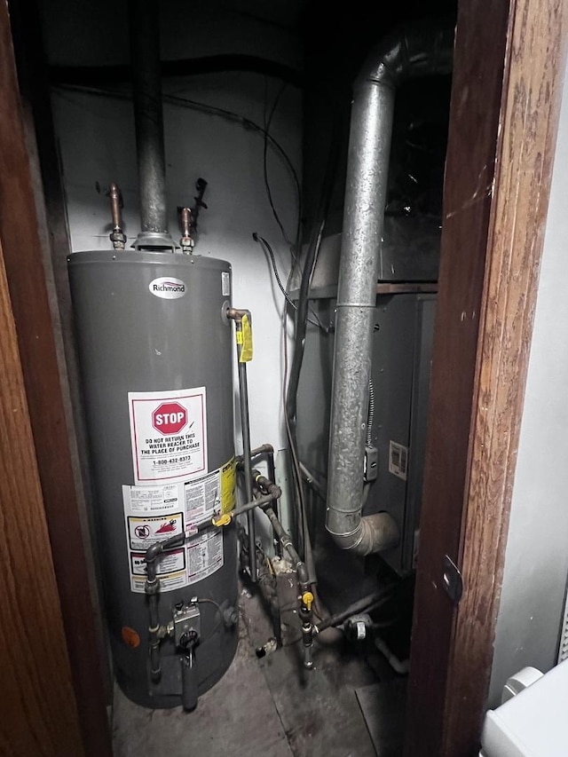 utility room featuring water heater