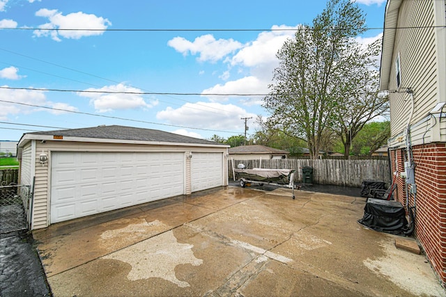 detached garage featuring fence
