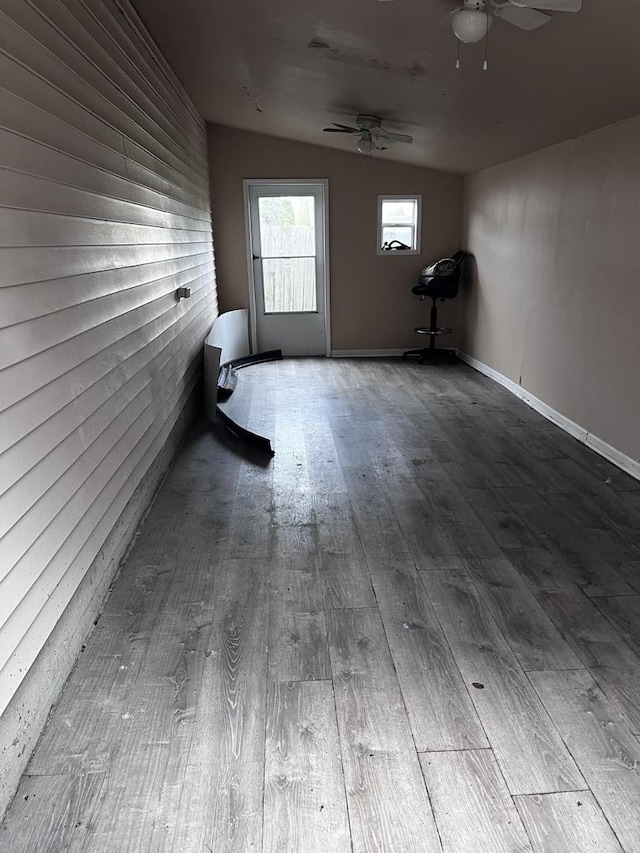 spare room featuring a ceiling fan, wood finished floors, and lofted ceiling