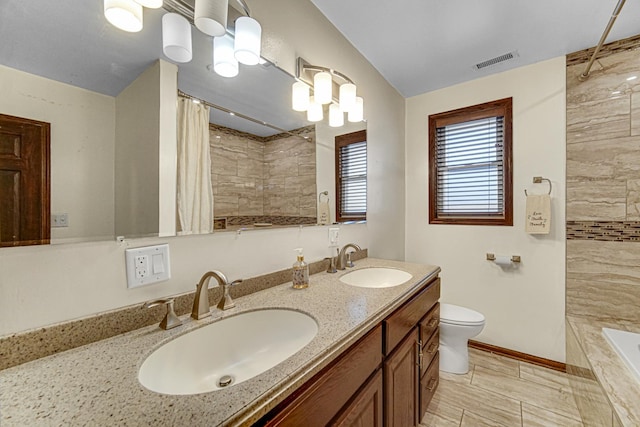 full bath featuring visible vents, a sink, and tiled shower