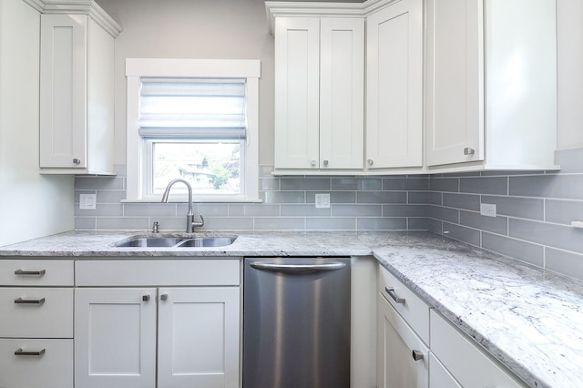 kitchen featuring a sink, dishwasher, decorative backsplash, light stone counters, and white cabinets