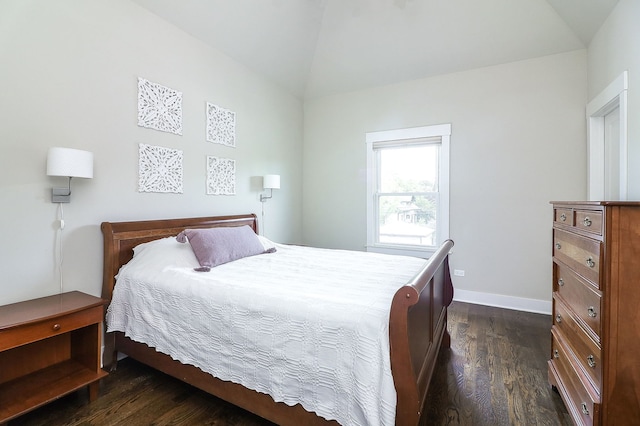bedroom with lofted ceiling, dark wood-type flooring, and baseboards