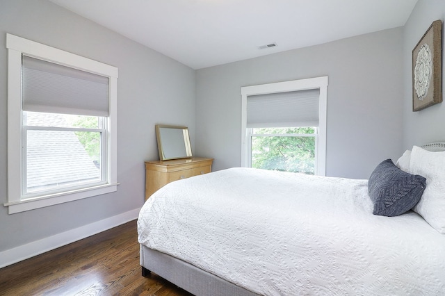 bedroom featuring dark wood finished floors and baseboards