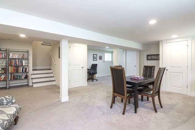 dining room featuring light colored carpet, recessed lighting, baseboards, and stairway