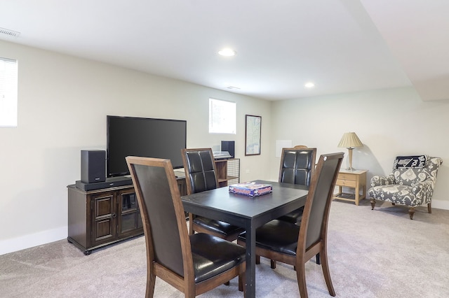 dining space featuring light colored carpet, baseboards, and recessed lighting