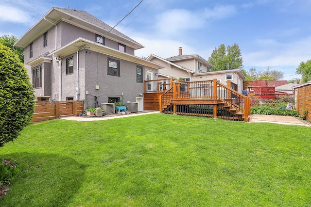 back of property featuring stairs, stucco siding, a deck, and central AC unit