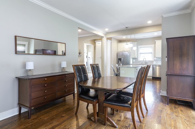 dining space featuring dark wood-type flooring, ornamental molding, baseboards, and recessed lighting
