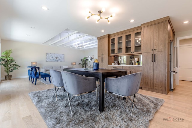 dining space with recessed lighting, light wood-style flooring, and baseboards