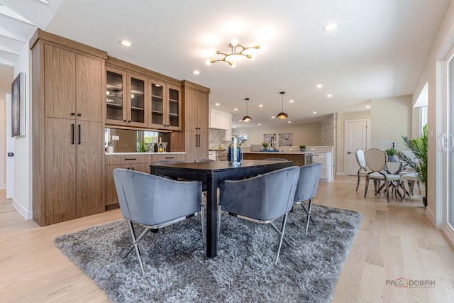 dining space with recessed lighting, baseboards, plenty of natural light, and light wood-style flooring