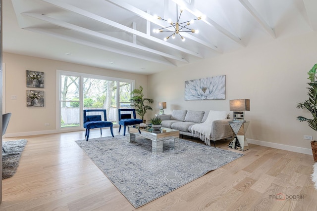 living area with light wood-style floors, baseboards, a fireplace, and beam ceiling