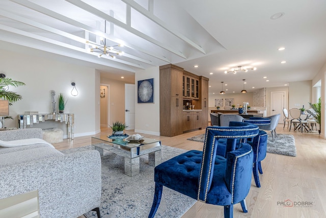 living area featuring recessed lighting, baseboards, a chandelier, and light wood finished floors