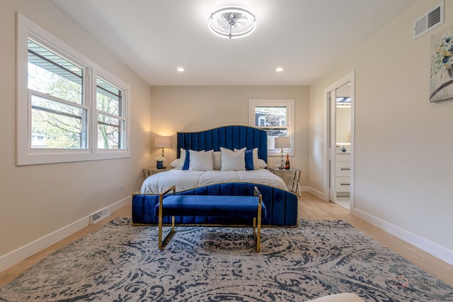 bedroom with visible vents, baseboards, and multiple windows