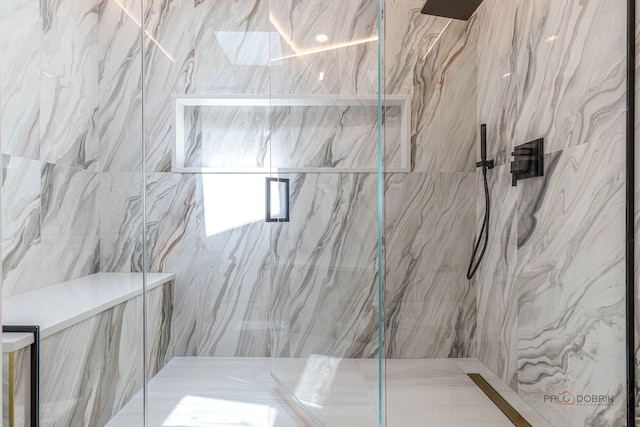 bathroom with a marble finish shower