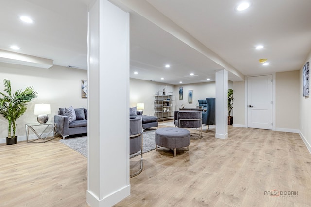 living room with baseboards, recessed lighting, and wood finished floors