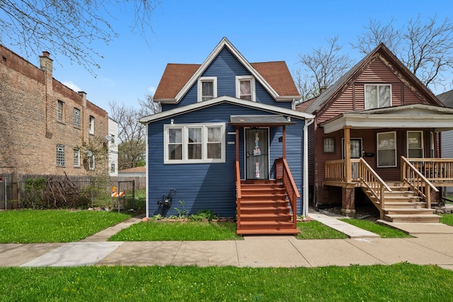 bungalow-style home featuring fence and a front yard