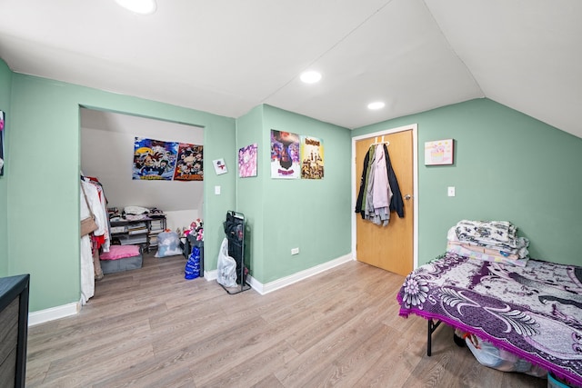 bedroom featuring baseboards, vaulted ceiling, recessed lighting, and wood finished floors