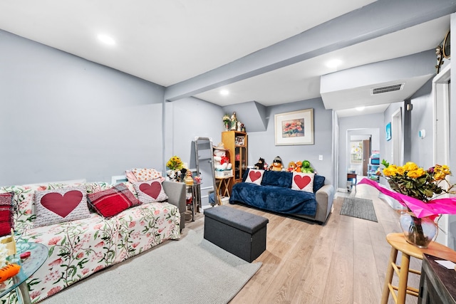 living area featuring recessed lighting, wood finished floors, and visible vents