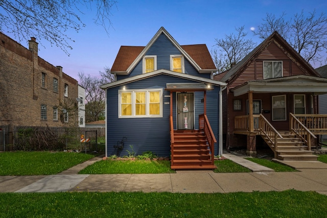 bungalow-style home with a porch and fence