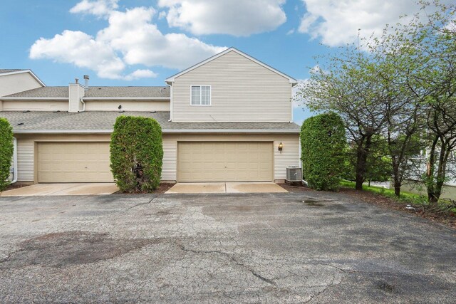 143 Foxglove Unit 143, Romeoville, IL 60446 - view of property exterior with cooling unit and a shingled roof
