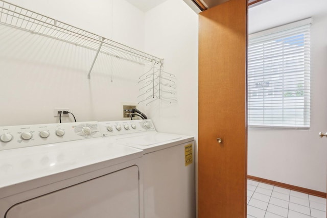 143 Foxglove Unit 143, Romeoville, IL 60446 - laundry area with independent washer and dryer, healthy amount of natural light, light tile patterned floors, and baseboards