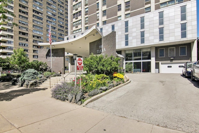 view of property featuring a garage and driveway