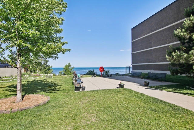 exterior space with a lawn and a water view