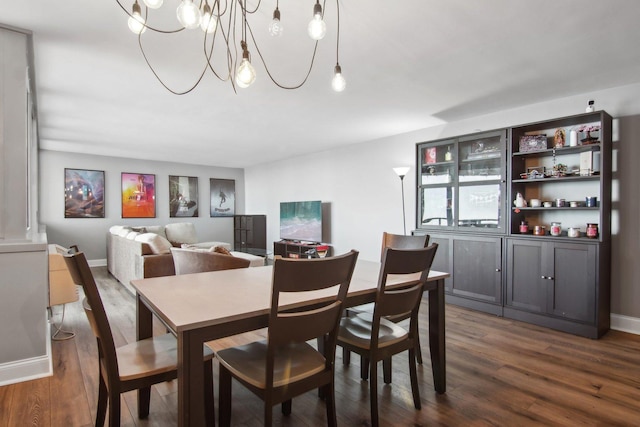dining space with an inviting chandelier and dark wood-type flooring