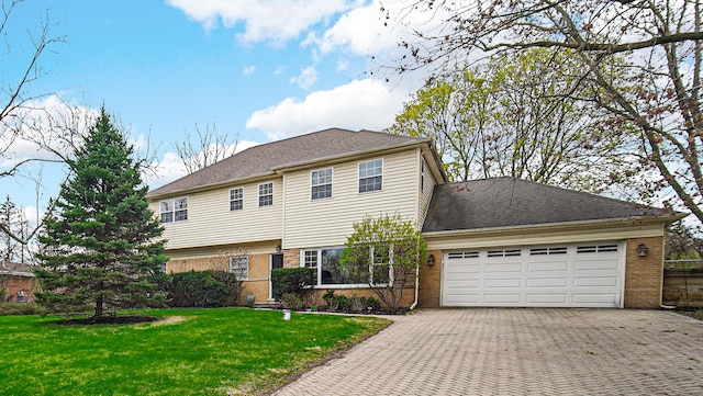 view of front facade featuring a garage, a front yard, decorative driveway, and brick siding