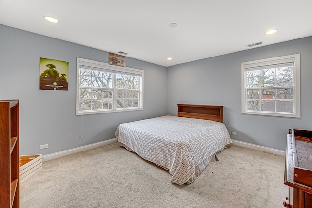 bedroom featuring baseboards, multiple windows, and carpet flooring