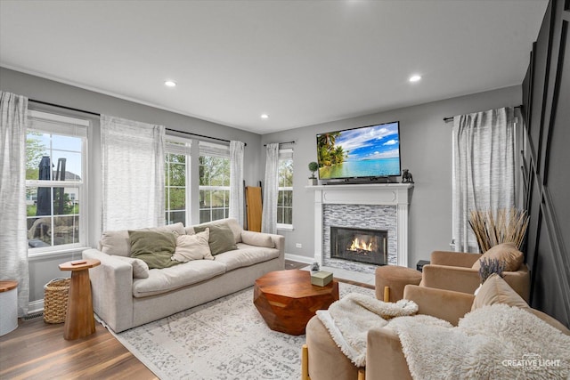 410 Blue Ridge Dr, Oswego, IL 60543 - living area with wood finished floors, a tiled fireplace, recessed lighting, and baseboards