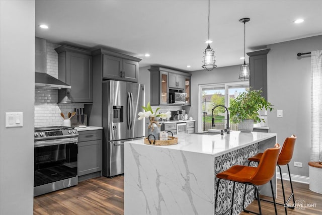 410 Blue Ridge Dr, Oswego, IL 60543 - kitchen featuring stainless steel appliances, a sink, wall chimney range hood, gray cabinets, and tasteful backsplash