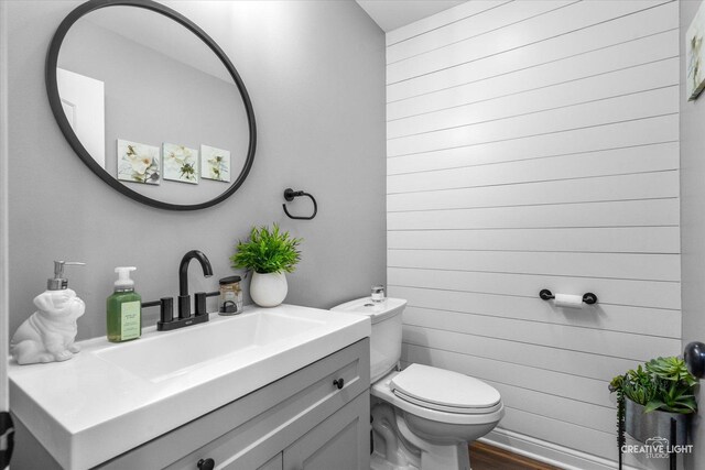 410 Blue Ridge Dr, Oswego, IL 60543 - half bath featuring toilet, wood finished floors, and vanity