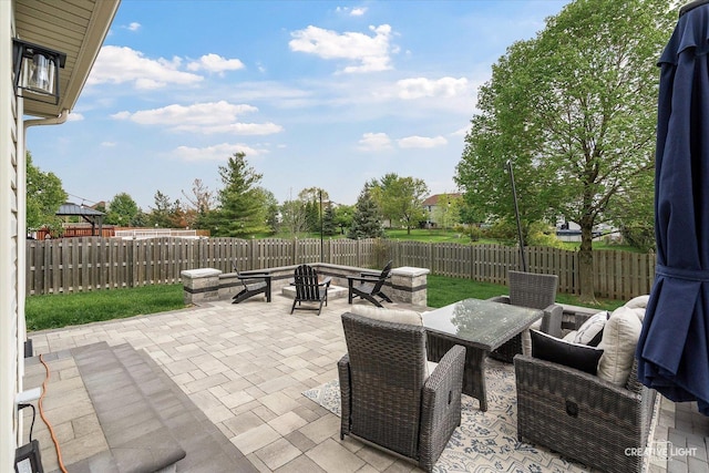 410 Blue Ridge Dr, Oswego, IL 60543 - view of patio / terrace with a fire pit, a fenced backyard, and outdoor dining space