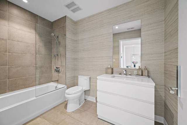full bathroom with visible vents, shower / bathing tub combination, toilet, and tile walls
