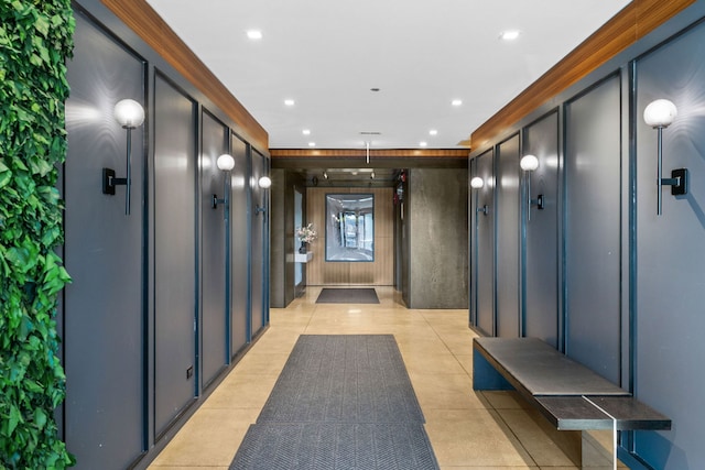 hall with crown molding, recessed lighting, and light tile patterned floors