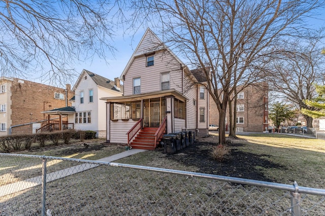 view of front of house featuring a fenced front yard and a sunroom